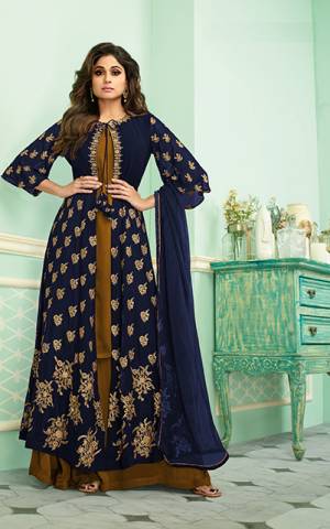 Get Ready For The Upcoming Festive And Wedding Season With This Heavy Designer Indo-Western Suit In Navy Blue And Golden Yellow Color. Its Elegant Embroidered And Bottom Are Fabricated On Georgette Paired With Chiffon Fabricated Dupatta. Buy Now.