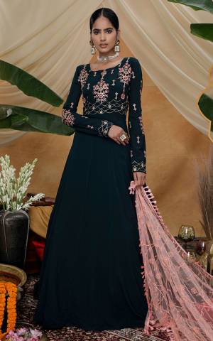 Flaunt Your Rich And Elegant Taste Wearing This Designer Floor Length Suit In Grey Color Paired With Contrasting Peach Colored Dupatta . Its Top Is Fabricated On Georgette Paired With Net Dupatta Beautified With Detailed Attractive Embroidery. 