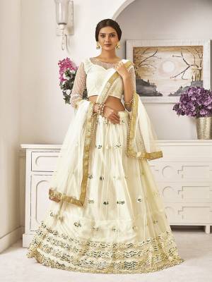 Flaunt Your Rich And Elegant Taste Wearing This Designer Lehenga Choli In Off-White Color. This Lovely Embroidered Piece Is Net Based Beautified With Attractive Embroidery. Buy Now.