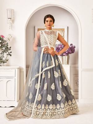 Flaunt Your Rich And Elegant Taste Wearing This Designer Lehenga Choli In Off-White And  Grey Color. This Lovely Embroidered Piece Is Net Based Beautified With Attractive Embroidery. Buy Now.