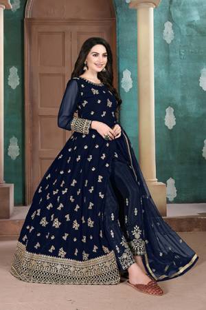 Here Is A Very Pretty Heavy Designer Indo-Western Suit In Navy BLue Color. Its Emnbroidred Floor Length To Is Fabricated On Georgette Paired With Embroidered Bottom Fabricated On Santoon and Net Fabricated Dupatta. 