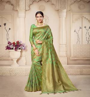 For A Proper Traditional Look, Grab This Pretty Designer Saree In Light Green Color. This Saree Is Banarasi Silk Based Beautified With Detailed Attractive Weave Paired With Art Silk Fabricated Blouse. Buy Now.