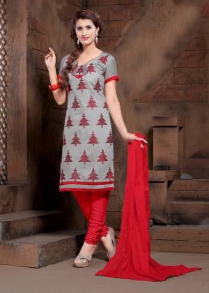 Add This Pretty Dress Material To Your Wardrobe In Grey Colored Top Paired With Red Colored Bottom And Dupatta. Its Top Is Modal Silk Based Paired With Cotton Bottom And Chiffon Fabricated Dupatta. 