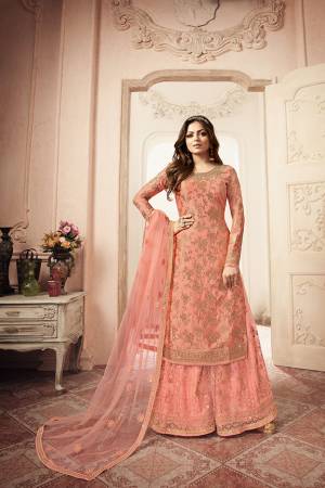 Look Pretty In This Lovely Heavy Designer Sharara Suit In Peach Color. Its Top Is Jacquard Silk Based Paired With Embroidered Net Fabricated Bottom And Dupatta. Buy Now. 