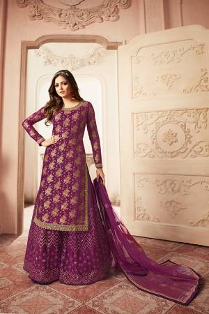You Will Definitely Earn Lots Of Compliments Wearing This Heavy Designer Sharara Suit In Purple Color. Its Top Is Fabricated Jacquard Silk Paired With Net Fabricated Embroidered Bottom And Net Dupatta. 