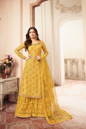 You Will Definitely Earn Lots Of Compliments Wearing This Heavy Designer Sharara Suit In Yellow Color. Its Top Is Fabricated Jacquard Silk Paired With Net Fabricated Embroidered Bottom And Net Dupatta. 