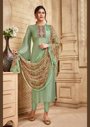 Here Is A Pretty Designer Straight Suit Suitable For The Upcoming Festive Season In This Lovely Pastel Green Color Paired With Multi Colored Dupatta. Its Top Is Fabricated On Saton Silk Beautified With Minimal Elegant Embroidery Paired With Santoon Bottom and Viscose Muslin Printed Dupatta. Buy this Pretty Suit Now.
