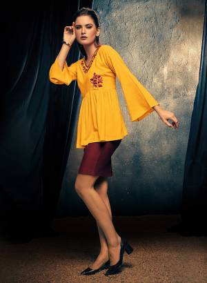 Here Is A Very Pretty Readymade Fancy Top In Musturd Yellow Color For Your College, Outing Or Work Place. This Top Is Fabricated On Rayon Beautified With Thread Work And Can Be Paired With Pants, Denim Or Skirt. 
