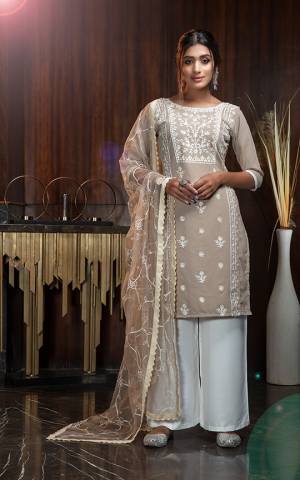 Grab This Very Pretty And Elegant Looking Designer Suit In Beige Color Paired With White Colored Bottom and Beige Colored Dupatta. Its Embroidered Top Is Georgette Based Paired With Rayon Bottom And Net Fabricated Embroidered Dupatta. 