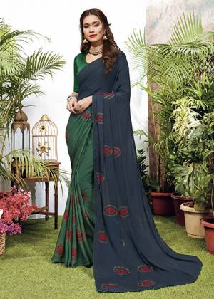 Celebrate This Festive Season With Beauty And Comfort Wearing This Designer Embroidered Saree In Navy Blue And Tela Green Color. This Saree Is Fabricated On Chiffon Paired With Art Silk Fabricated Blouse. 