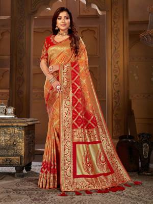 Shine Bright Wearing This Designer Saree In Orange And Red Color Paired With Red Colored Blouse. This Pretty Weaved Saree Is Fabricated On Jacquard Silk Paired With Art Silk Fabricated Embroidered Blouse. 
