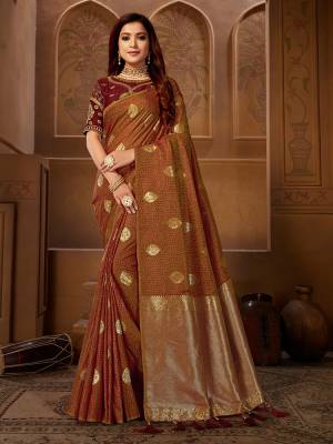 Shine Bright Wearing This Designer Saree In Brown Color Paired With Dark Brown Colored Blouse. This Pretty Weaved Saree Is Fabricated On Jacquard Silk Paired With Art Silk Fabricated Embroidered Blouse. 