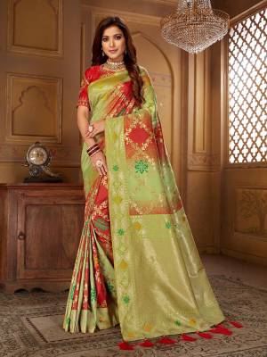 Shine Bright Wearing This Designer Saree In Light Green and Red Color Paired With Red Colored Blouse. This Pretty Weaved Saree Is Fabricated On Jacquard Silk Paired With Art Silk Fabricated Embroidered Blouse. 
