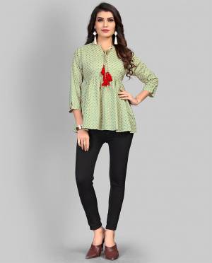 Here Is A Pretty Elegant Looking Readymade Top In Light Green Color Fabricated On Cotton Beautified With Prints. It Is Light In Weight And Can Be Paired With Denim Or Pants. 