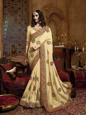 Flaunt Your Rich And Elegant In This Pretty Cream Colored Heavy Embroidered Saree. This Saree Is Fabricated On Satin Silk Paired With Art Silk Fabricated Blouse. Buy This Heavy Designer Saree Now. 