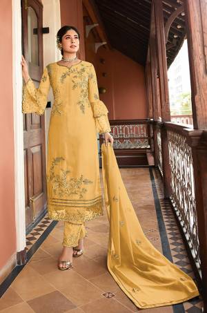 This Festive And Wedding Season, Be The Most Beautiful Diva Wearing This Designer Straight Suit In Yellow Color. Its Embroidered Top Is Fabricated on Satin Georgette Paired With Santoon Bottom And Chiffon Dupatta. Buy Now.