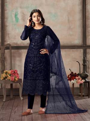 Here Is A Very Beautiful Designer Straight Suit In All Over Navy Blue Color. Its Heavy Embroidered Top Is Fabricated On Net Paired With Santoon Bottom And Net Fabricated Dupatta. Its Top Is Beautified With Heavy Tone To Tone Embroidery Which Gives A Rich And Elegant Look To Your Personality. 