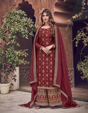 Here Is A Designer Heavy Straight Suit In Maroon Color. Its Top Is Fabricated On Jacquard Silk Paired With Art Silk Fabricated Bottom Paired With Chiffon Fabricated Dupatta. It Is Beautified With Heavy Embroidery Giving An Attractive Look. 
