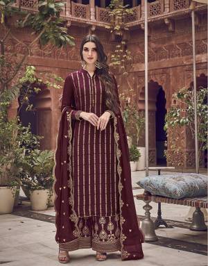 Here Is A Designer Heavy Straight Suit In Maroon Color. Its Top Is Fabricated On Jacquard Silk Paired With Art Silk Fabricated Bottom Paired With Chiffon Fabricated Dupatta. It Is Beautified With Heavy Embroidery Giving An Attractive Look. 