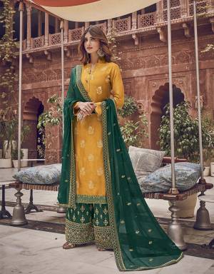 Grab This Very Beautiful Designer Straight Suit In Yellow Color Paired With Contrasting Pine Green Colored Bottom And Dupatta. Its Top Is Fabricated On Jacquard Silk Paired With Art Silk Fabricated Bottom and Chiffon Dupatta. 