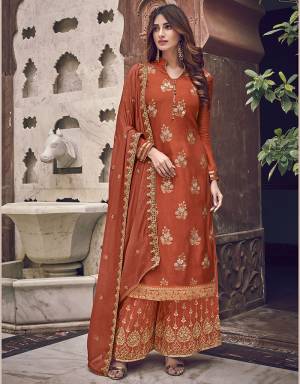 Here Is A Designer Heavy Straight Suit In Orange Color. Its Top Is Fabricated On Jacquard Silk Paired With Art Silk Fabricated Bottom Paired With Chiffon Fabricated Dupatta. It Is Beautified With Heavy Embroidery Giving An Attractive Look. 