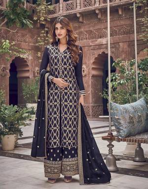 Enhance Your Personality Wearing This Heavy Designer Straight Suit In Navy Blue Color. Its Top Is Jacquard Silk Based Paired With Art Silk Fabricated Embroidered Bottom And Chiffon Dupatta. Its Rich Color and Fabric Will Earn You Lots Of Compliments From Onlookers. 