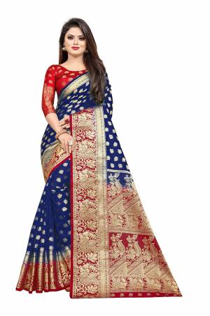 Celebrate This Festive Season In A Proper Traditonal Look Wearing This Silk Based Saree In Royal Blue Color Paired With Red Colored Blouse. This Saree And Blouse Are Fabricated On Art Silk Beautified with Weave. 