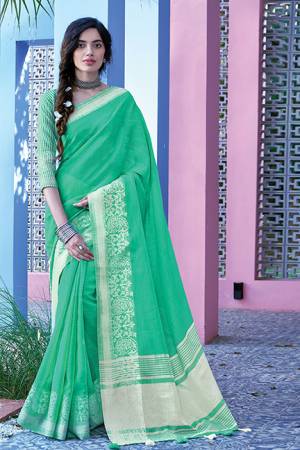 Simple And Elegant Looking Saree Is Here In Green Color Paired With Green Colored Blouse. This Saree And Blouse Are Fabricated On Linen Cotton Beautified With Weave. Buy This Saree Now.