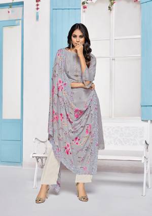 Grab This Very Pretty Designer Straight Suit In Grey Colored Top Paired With White Colored Bottom And Grey Colored Dupatta. Its Top Is Fabricated On Chinon Paired With Crepe Bottom And Chiffon Fabricated Dupatta. Its Pretty Floral Prints And Tone To Tone Embroidery Gives An Elegant Look To Your Personality. 