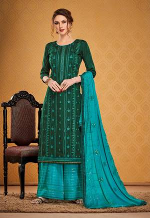 You Will Definitely Earn Lots Of Compliments Wearing This Designer Straight Suit In Dark Green Color Paired With Blue Colored Bottom and Dupatta. Its Top Is Fabricated On Cotton Silk Paired With Rayon Silk Bottom and Chinon Fabricated Dupatta. 