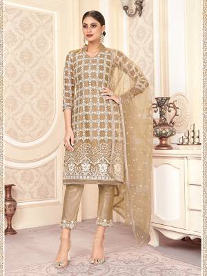 Look Pretty In This Designer Straight Suit In Beige Color. IT Heavy Embroidered Top And Dupatta Are Net Based Paired With Santoon Fabricated Bottom. ItsPretty Color And elegant Embroidery Will Give A Rich Look To Your Personality. 