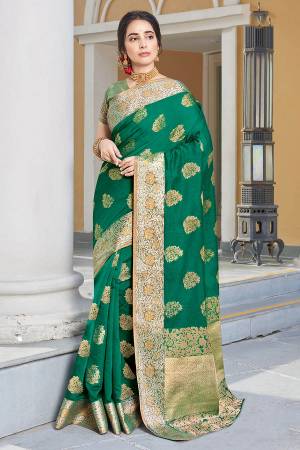 Celebrate This Festive Season Wearing This Pretty Green Colored Designer Saree. This Saree And Blouse Are Fabricated On Art Silk Beautified With Weave All Over. Buy Now.