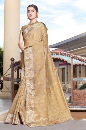 Here Is Pretty Rich Looking Silk Based Saree In Beige Color Paired With Navy Blue Colored Blouse. This Saree And Blouse Are Fabricated On Art Silk Beautified With Weave All Over. 