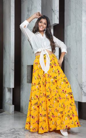 Grab This Pretty Readymade Designer Skirt Top In White Colored Top Paired With Yellow Colored Skirt. Its Plain Top Is Fabricated On Rayon Paired With Crepe Fabricated Printed Skirt. 
