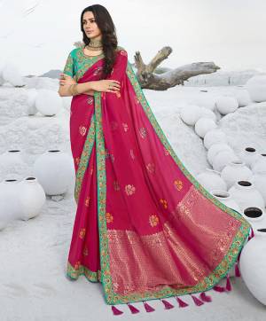 Look Attractive Wearing This Designer Saree In Dark Pink Color Paired with Contrasting Sea Green Colored Blouse. This Pretty Saree Is Fabricated On Jacquard Silk Paired With Art Silk Fabricated Embroidered Blouse. Its Rich Fabric And Color Pallete Will Earn You Lots Of Compliments From Onlookers. 