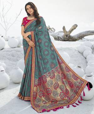 Add This Beautiful Designer Saree To Your Wardrobe For The Upcoming Wedding and Festive Season In Grey and Blue Color Paired With Contrasting Dark Pink Colored Blouse. This Saree Is Fabricated On Jacquard Silk Paired With Art Silk Fabricated Blouse. 