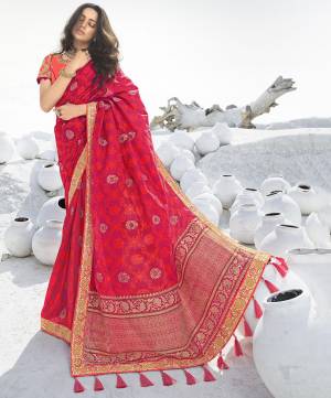 Look Attractive Wearing This Designer Saree In Dark Pink Color Paired with Contrasting Orange Colored Blouse. This Pretty Saree Is Fabricated On Jacquard Silk Paired With Art Silk Fabricated Embroidered Blouse. Its Rich Fabric And Color Pallete Will Earn You Lots Of Compliments From Onlookers. 