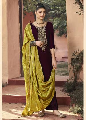 Get Ready For The Upcoming Wedding And Festive Season With This Trendy Designer straight Suit In Wine Color Paired With Pine Green Colored Dupatta. Its Elegant Neck Embroidered Top Is Fabricated On Velvet Paired With Santoon Bottom and Chinon Fabricated Bandhani Print Dupatta. 