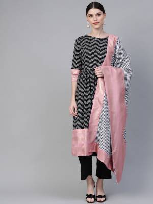 For Your Semi-Casual Wear, Grab This Readymade Suit In Black Color Paired With White And Black Dupatta Highlighted With Baby Pink Color. This Suit Is Crepe Based Beautified With Prints. 