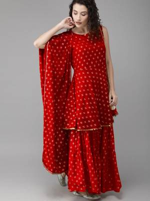 Grab This Beautiful Readymade Sharara Suit In All over Red Color. Its Top, Bottom And Dupatta Are Fabricated On Georgette Beautified With Intricate Prints. 