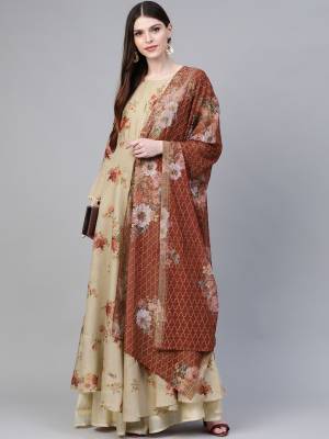 Flaunt Your Rich And Elegant Taste Wearing This Beautiful Readymade Floor Length Suit In Beige color Paired With Brown Colored Dupatta. Its Top Is Polyester Based Paired With Georgette Fabricated dupatta. 
