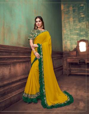 The excellence of a beautiful silk-based fabric,
Warmed in traditional hues of yellow and green and transformed to modern outlook with frill details and designer cut-work hemmed blouse this saree is re-evolved to bring your uber- stylish look alive.