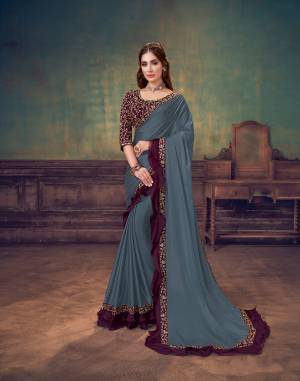 Let your celebratory escapades be much more fun when the effortlessness of deep dark shades and purity of masterful designs filled with delicate embroideries and frilly ingredient serve your vibrant energy. The contrast hue of deep purple
makes the bluish-grey saree stand out. 