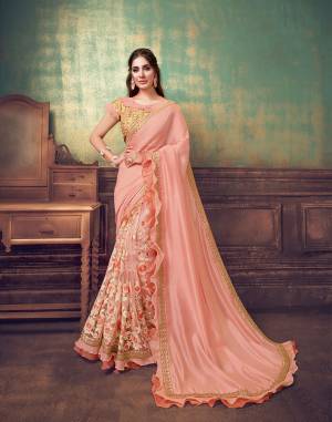 In the new iterations of soft pastel tones ? deft embroideries , masterful tailoring and accents of glam-filled glittery touch and two-layered frills for a surreal appeal? this half-half net and silk peach saree is timeless yet very modern. The very, very designer touch to the blouse makes the saree all the more interesting.