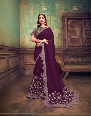 With very minutely embroidered
floral embroidery with double sequins details and a contrast dual tone blouse that?s delicate and classy to compliment the strong shade of burgundy and very feminine frills- this saree is sure to appeal every women who like to dress up
strong and well.