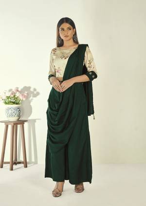 Grab This Indo-Western Two Piece Set Of A Blouse with Drape Bottom. Its Floral Printed Cream Colored Blouse Is Paired With Dark Green Colored Drape Bottom. Its Blouse Is Fabricated on Satin Paired With Soft Art Silk bottom. Buy This Readymade Set Now.