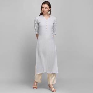 Grab This Simple And Elegant Readymade Pair Of Kurti and Plazzo In Grey And Yellow Color. This Pretty Pair Is Fabricated On Rayon Beautified With Lining Prints. It Is Light In Weight And Easy To Carry All Day Long. 