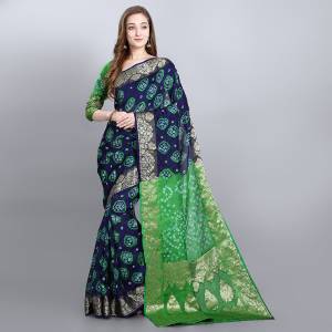 Celebrate This Festive Seasobn With Beauty and Comfort Wearing This Bandhani Prnted Saree In Navy Blue and Green Color. This Saree and Blouse Are Fabricated On Viscose Georgette Which Is Light Weight And Ensures Superb Comfort Throughout The Gala.