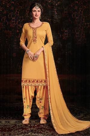Grab This Beautiful Designer Suit For This Festive Season In Musturd Yellow color. Its Embroidered Top Is Fabricated On Cotton Satin Paired With Floral Printed Cotton Bottom And Chiffon Fabricated Dupatta. 
