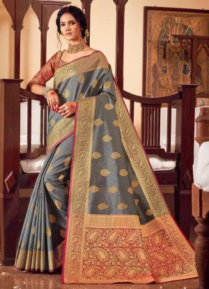 Celebrate This Festive Season In A Lovely Traditional Look Wearing This Designer saree In Grey Color Paired With Dark Pink Colored Blouse. This Saree And Blouse Are Fabricated On Handloom Silk Beautified With Heavy Weave.